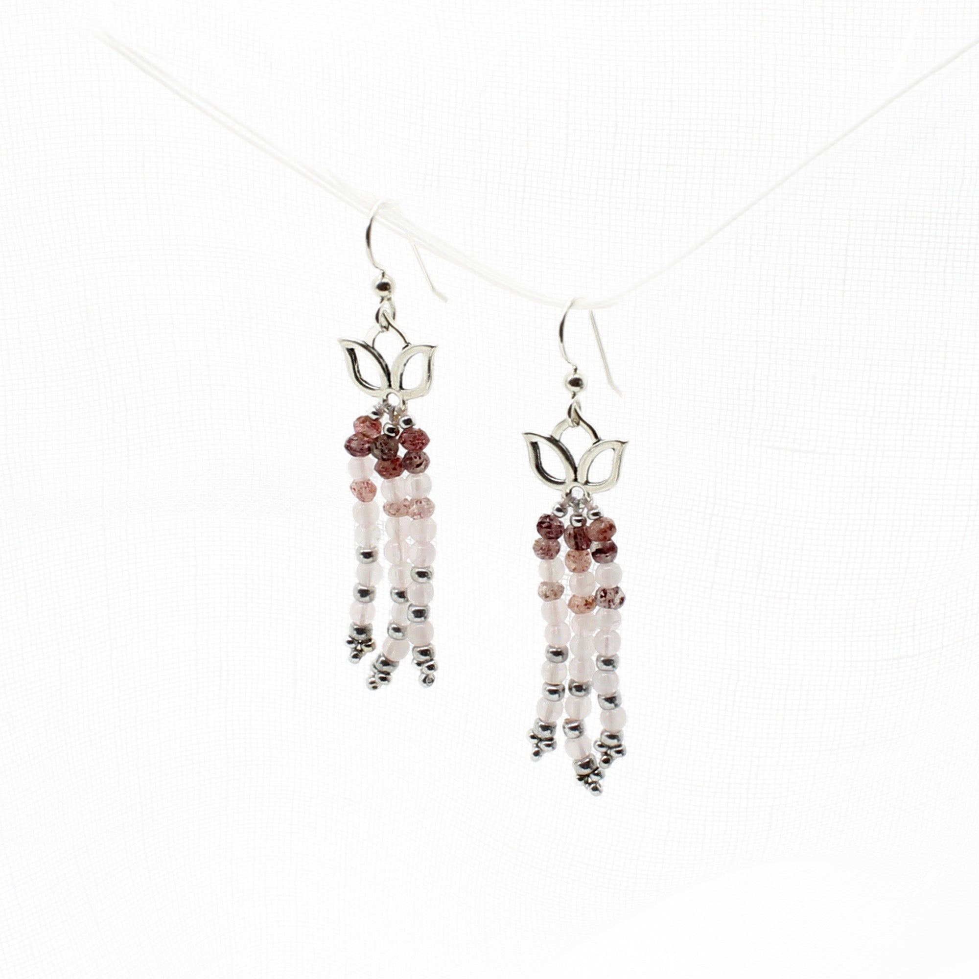 Rose Quartz and Lodolite Gemstones dangle from silver lotus earrings.