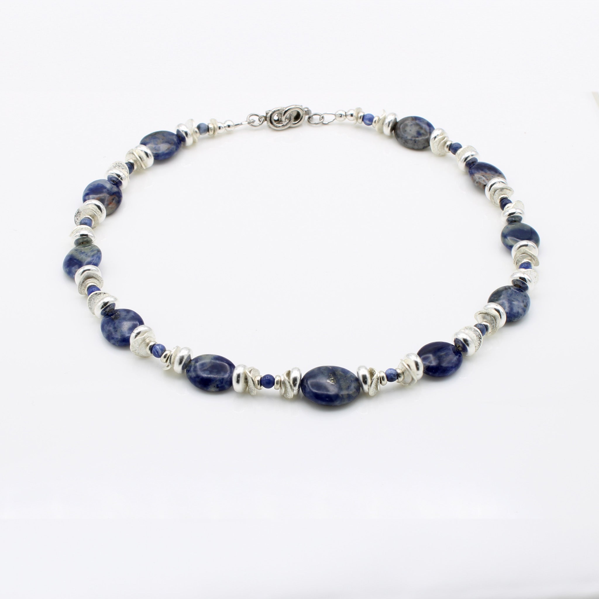 Blue Sodalite hand strung with Silver beads and Platinum plated clasp.