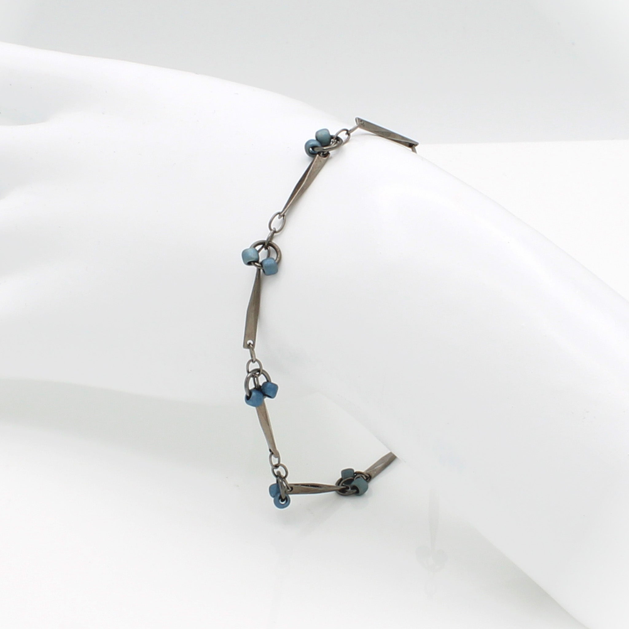 Gun-metal twisted chain link with ice blue glass beads bracelet.