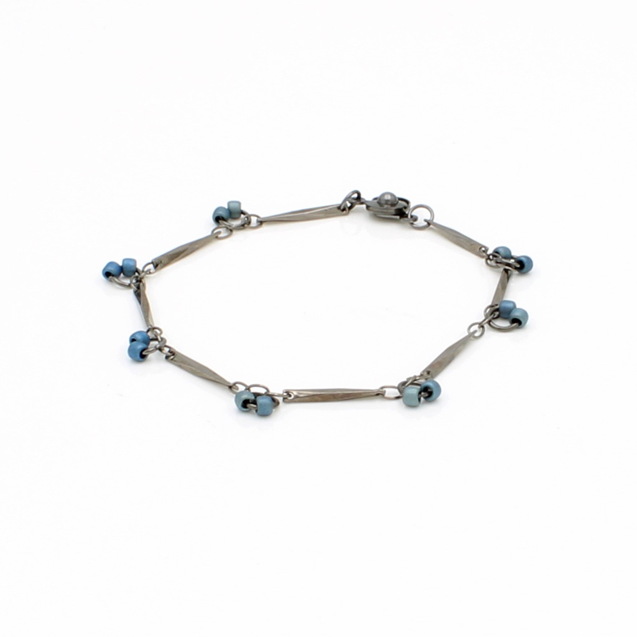 Dainty chain bracelet in gunmetal finish and steel blue glass beads.